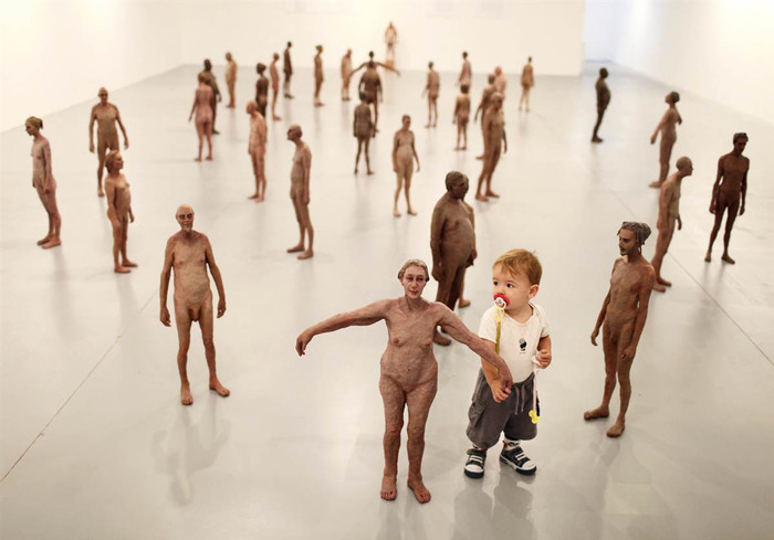 Một em bé người Israel đang nắm tay bức tượng đang được trưng bày tại triển lãm Artists House tại Tel Aviv ngày 28/10/2011.