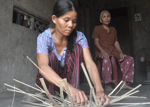 Chị Ngô Thị Tư đan giỏ trẻ bán kiếm tiền để mua máu cho chồng chạy thận. Ảnh: Trí Tín. Chị Ngô Thị Tư đan giỏ trẻ bán kiếm tiền để mua máu cho chồng chạy thận. Ảnh: Trí Tín.