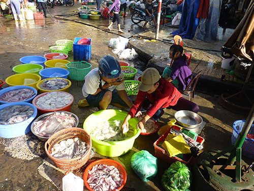 Sơ chế mực trước khi bán cho khách tại khu vực chợ Hòa Bình, quận 5 - TPHCM