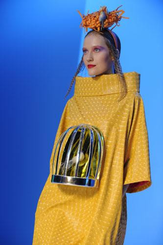 Chiếc váy màu vàng chóe được gắn "phụ kiện" là chiếc lồng chim trước ngực và tổ chim trên đầu sẽ rất hợp cho những ai có thú chơi chim cảnh. Tuy nhiên, nếu hỏi những người ăn với chim, ngủ với chim hẳn chẳng ai dám diện lên mình kiểu thời trang này.
