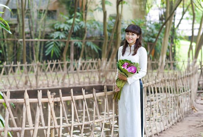 Làm duyên với hoa sen hồng càng tôn lên vẻ đẹp thanh lịch, quý phái của người con gái Việt.