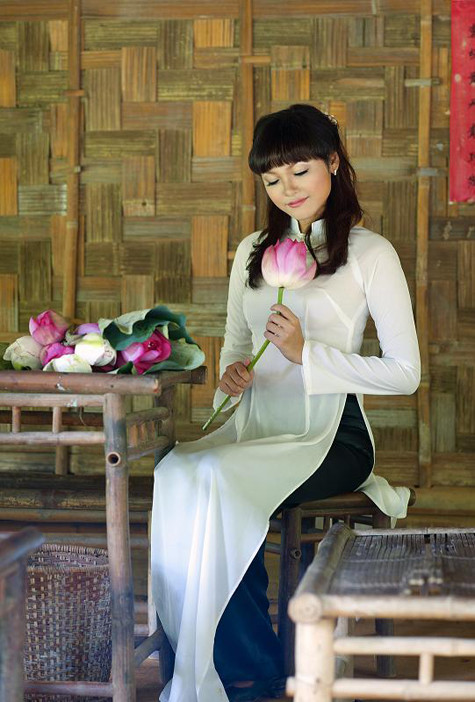 Thiếu nữ e ấp như đóa sen hồng bên bộ tràng kỷ.