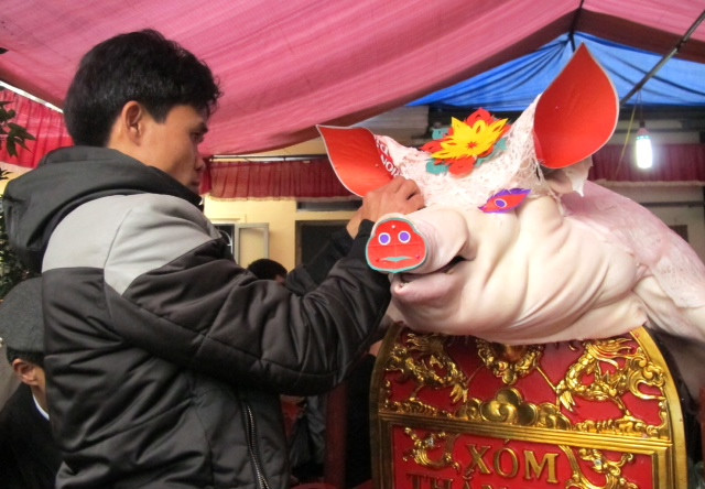 Những “ông lợn” được trang trí rất long trọng và kì công, trước khi rước ra đình làng. Những “ông lợn” được trang trí rất long trọng và kì công, trước khi rước ra đình làng.