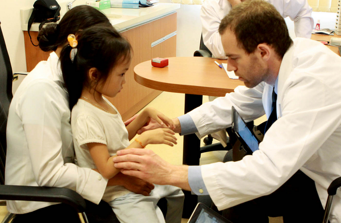 Bé Phạm Thị Hồng Ngát, 7 tuổi bị co rút bàn tay trái.