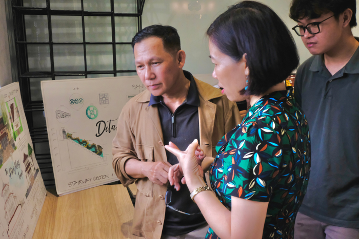 Thạc sĩ, Kiến trúc sư Nguyễn Quốc Vinh (áo nâu) xem sản phẩm của sinh viên ngành Kiến trúc (Ảnh: Website trường) Thiet-ke-chua-co-ten-3.png