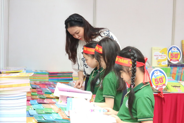 Nhiều độc giả nhí thích thú tìm hiểu sách tại gian trưng bày của Nhà xuất bản Giáo dục Việt Nam. Ảnh: Ngọc Huyền GDVN_phó gd.JPG
