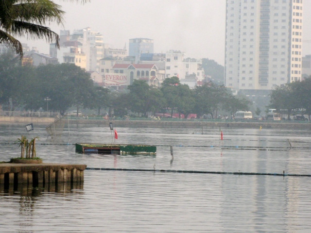 Một góc hồ Tây phía giáp với đường Yên Phụ trở nên lộn xộn với chi chít cọc và thùng phi nổi. Một góc hồ Tây phía giáp với đường Yên Phụ trở nên lộn xộn với chi chít cọc và thùng phi nổi.