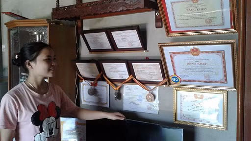 Em Nguyễn Thị Huệ bên cạnh những thành tích xuất sắc của mình (Ảnh: Nguyễn Thanh Tiến).