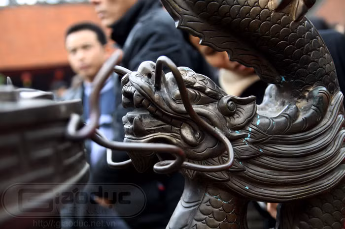 Một con rồng chầu bên phải đỉnh đồng...