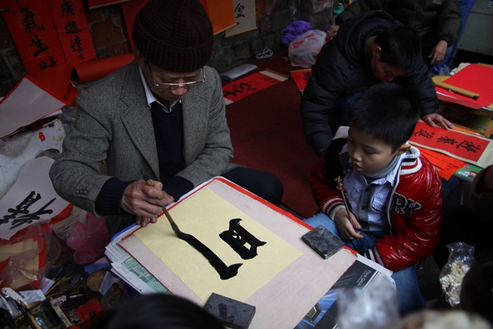 Phía bên ngoài đường Quốc Tử Giám, "phố ông đồ" cũng nhộn nhịp cảnh cho chữ, xin chữ. Phía bên ngoài đường Quốc Tử Giám, "phố ông đồ" cũng nhộn nhịp cảnh cho chữ, xin chữ.