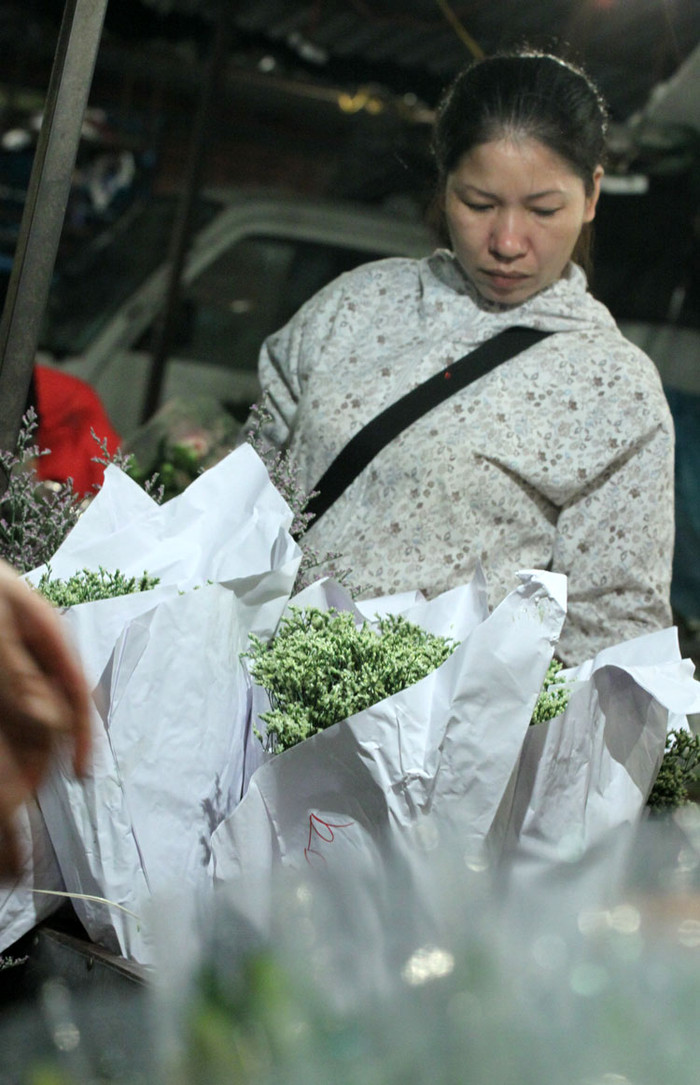 Chị Thúy, một người kinh doanh hoa tươi ở Hà Đông đang tìm cho mình những bó hoa ưng ý. Chị Thúy, một người kinh doanh hoa tươi ở Hà Đông đang tìm cho mình những bó hoa ưng ý.