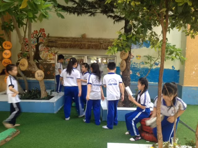 HS đến thư viên chọn sách rồi ngồi xuống gốc cây xanh chăm chú đọc.JPG