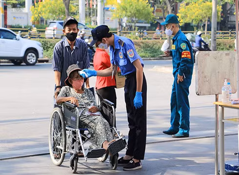 Người dân tới nhận quà được đo thân nhiệt kỹ lưỡng (ảnh: P.L)