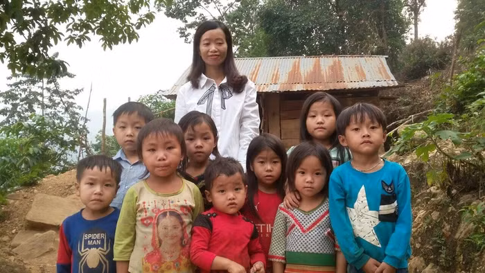 Cô giáo Trương Thị Dung cùng học sinh trước điểm Trường mầm non số 2 xã Nậm Hàng. Ảnh: GVCC.