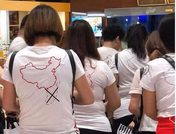 Một số du khách Trung Quốc mặc áo thun in hình lưỡi bò nhập cảnh tại cảng hàng không quốc tế Cam Ranh tối 13/5 bị lực lượng chức năng Việt Nam phát hiện và xử lý. Ảnh: Pháp luật Thành phố Hồ Chí Minh.