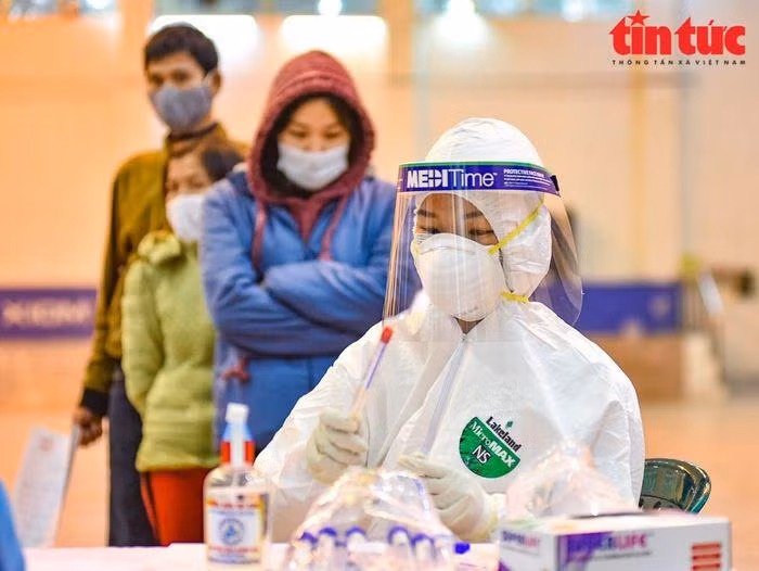 Lấy mẫu xét nghiệm sàng lọc COVID-19 cho người dân. (Ảnh: Trung Nguyên/TTXVN)