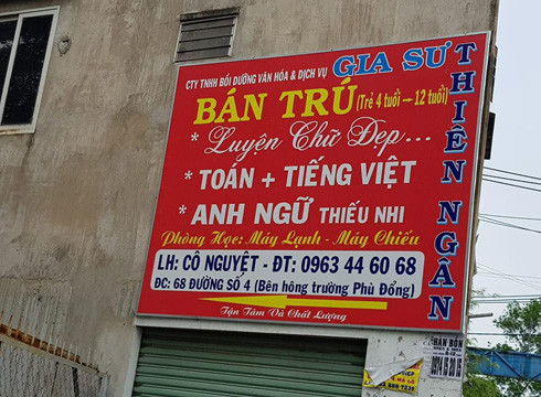 Một bảng quảng cáo của Thiên Ngân được treo trên bờ tường bên hông một trường tiểu học (ảnh: P.L)