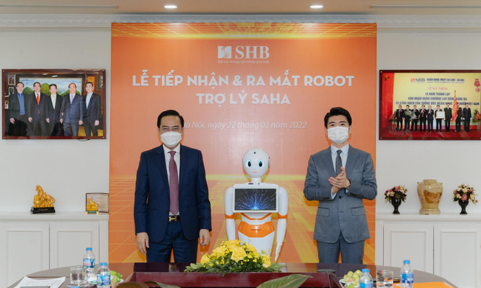 Ông Đỗ Quang Vinh – Phó Tổng Giám đốc SHB (bên phải) cùng ông Trần Mạnh Hà – Phó Tổng Giám đốc AIC Group chào mừng Robot Trợ lý SAHA chính thức gia nhập đại gia đình SHB Ông Đỗ Quang Vinh – Phó Tổng Giám đốc SHB (bên phải) cùng ông Trần Mạnh Hà – Phó Tổng Giám đốc AIC Group chào mừng Robot Trợ lý SAHA chính thức gia nhập đại gia đình SHB