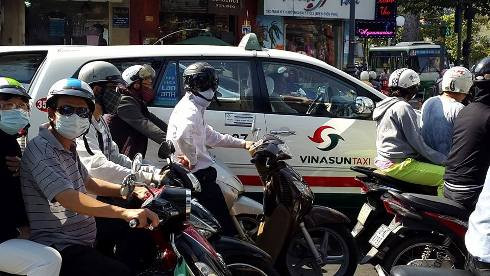 Nắng nóng kinh hoàng làm người đi đường ở Sài Gòn phải bịt kín mít (ảnh: T.P)