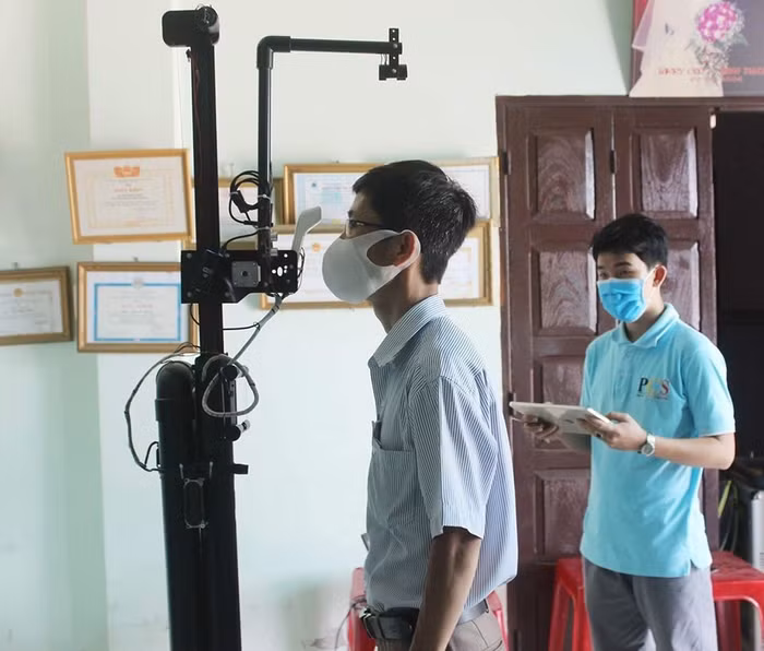 Thầy Bùi Minh Thảo đang sử dụng máy đo thân nhiệt - rửa tay sát khuẩn không tiếp xúc. (Ảnh: Nhân vật cung cấp)