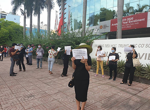 Phụ huynh cầm giấy với dòng chữ in phản đối chính sách thu học phí mùa dịch bệnh của VAS vào sáng 5/5 (ảnh: P.L) Phụ huynh cầm giấy với dòng chữ in phản đối chính sách thu học phí mùa dịch bệnh của VAS vào sáng 5/5 (ảnh: P.L)