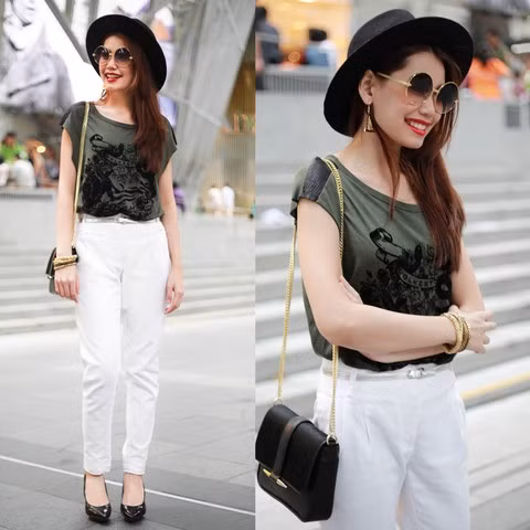 Chiếc quần trắng cạp cao cùng phụ kiện thanh lịch là chiếc túi xách đeo vai dây xích giúp bạn gái này thể hiện phong cách nổi bật và hiện đại.