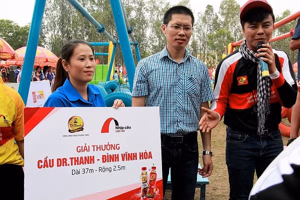 Ông Nguyễn Chung Hiếu (đứng giữa), đại diện tập đoàn Tân Hiệp Phát trao tặng cây cầu Dr Thanh – Đình Vĩnh Hòa cho người dân địa phương.