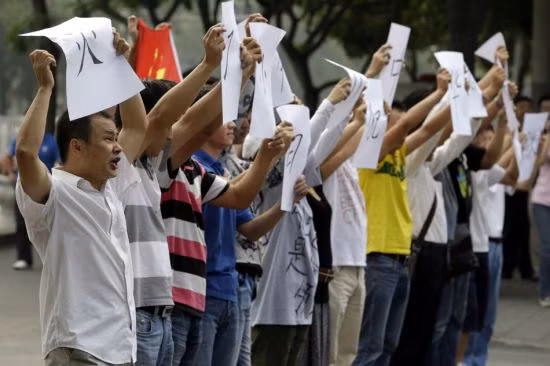 ...và những tấm biển, tờ giấy phản đối động thái mới nhất của Nhật Bản đối với nhóm đảo tranh chấp.