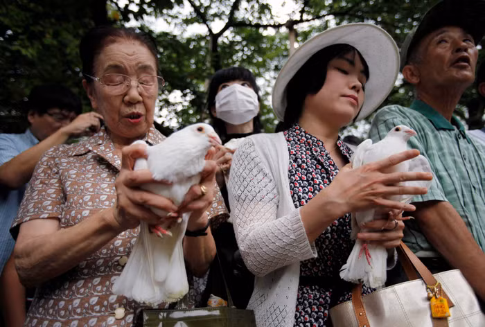 Những người dân cầu nguyện và chuẩn bị thả chim bồ câu.