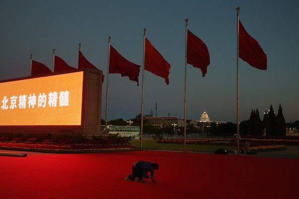 Một công nhân đang làm phẳng chiếc thảm đỏ.