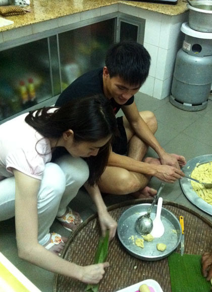 Bên người yêu, nữ ca sĩ tỉ mỉ cho đậu xanh đã đồ làm nhân và cẩn thận gói trong lá. Bên người yêu, nữ ca sĩ tỉ mỉ cho đậu xanh đã đồ làm nhân và cẩn thận gói trong lá.