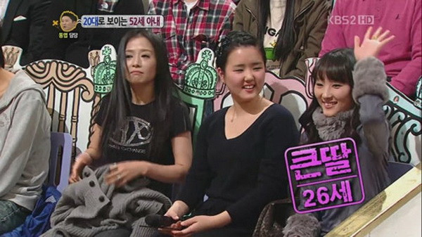 Bà ngồi cạnh hai cô con gái của mình. Con gái lớn (người giơ tay) đã 26 tuổi. Bà ngồi cạnh hai cô con gái của mình. Con gái lớn (người giơ tay) đã 26 tuổi.