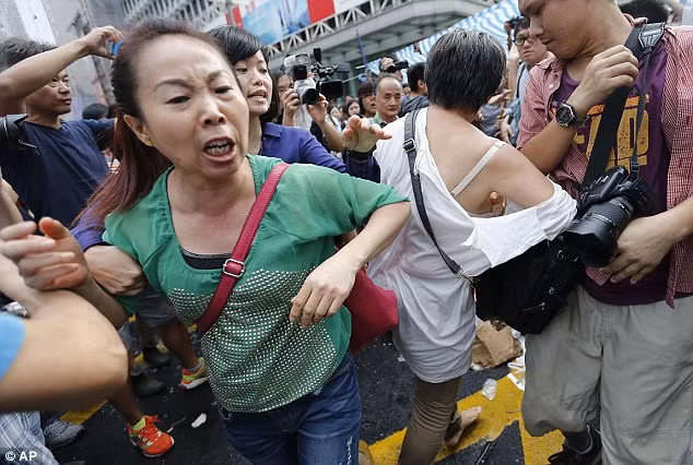 Những người ủng hộ Bắc Kinh cố gắng xông vào khu vực của sinh viên biểu tình. Những người ủng hộ Bắc Kinh cố gắng xông vào khu vực của sinh viên biểu tình.