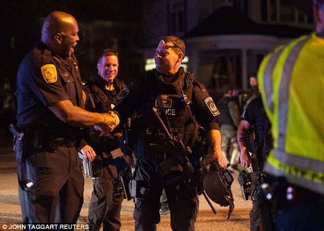 Hai viên cảnh sát Mỹ ăn mừng khi cuộc truy lùng kéo dài 24 giờ đầy căng thẳng kết thúc.