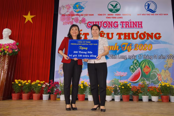 Bà Lê Thị Thúy Kiều (trái), Chủ tịch Hội Liên hiệp Phụ nữ tỉnh Vĩnh Long, đại diện trẻ em nghèo nhận 500 thùng sữa của Công ty FrieslandCampina Việt Nam từ bà Nguyễn Thị Tuyết Mai, Trưởng Ban Gia đình - Xã hội, Trung Ương Hội Liên Hiệp Phụ Nữ Việt Nam.