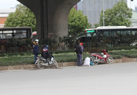 Nhiều người đứng dưới gầm cầu vượt, bên cạnh bến xe Mỹ Đình chờ xe (ảnh: THỤY DU).