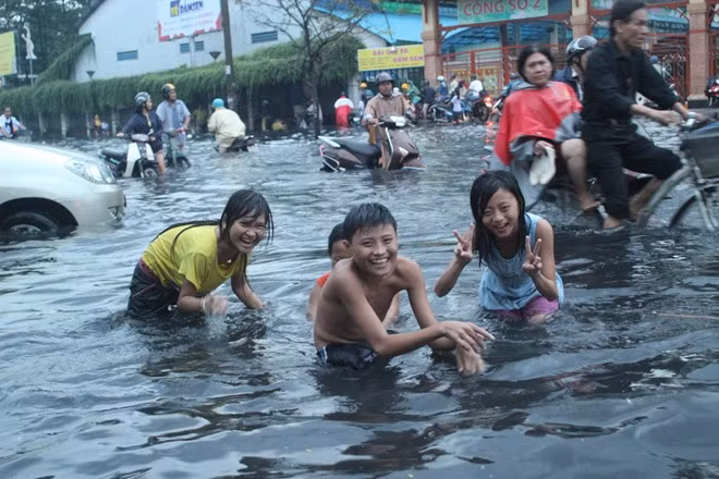 Trẻ con Sài Gòn vui đùa trên dòng nước đen Trẻ con Sài Gòn vui đùa trên dòng nước đen