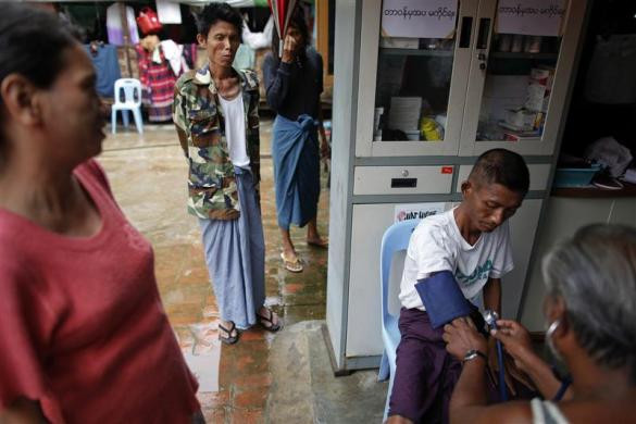 Một bác sĩ tình nguyện đo huyết áp cho bệnh nhân HIV tại nhà tế bần ở ngoại ô thành phố Yangon, Myanmar ngày 26/5/2012.