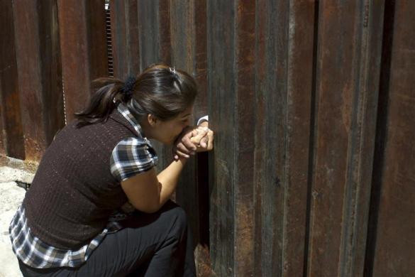 Mayda Reyes Lujan, hôn tay chồng qua các bức tường ngăn cách thành phố Nogales Sonora của Mexico và Nogales Arizona ngày 1 tháng 5 năm 2010. Mayda Reyes Lujan, hôn tay chồng qua các bức tường ngăn cách thành phố Nogales Sonora của Mexico và Nogales Arizona ngày 1 tháng 5 năm 2010.