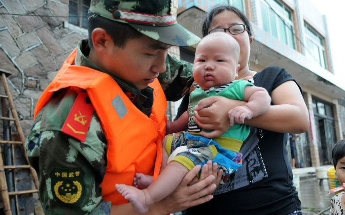 Một quân nhân giúp người dân di tản ở thành phố Ôn Châu. Một quân nhân giúp người dân di tản ở thành phố Ôn Châu.