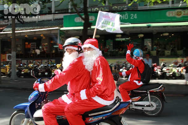 Thay vì cưỡi tuần lộc, các ông già Noel đèo nhau bằng xe máy trong trang phục đỏ rực như thắp lửa các tuyến đường trung tâm TP HCM. Thay vì cưỡi tuần lộc, các ông già Noel đèo nhau bằng xe máy trong trang phục đỏ rực như thắp lửa các tuyến đường trung tâm TP HCM.