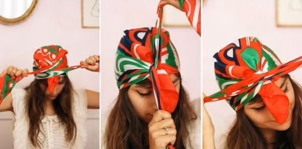 Quấn quanh đầu rồi thắt nút đầu tiên trước trán.