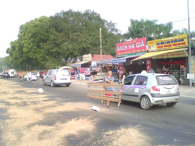 Một người dân mang phên tre ra cảnh báo đoạn đường nguy hiểm.