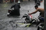 Mưa lớn, người dân TP Hồ Chí Minh “vật lộn” với dòng nước đen