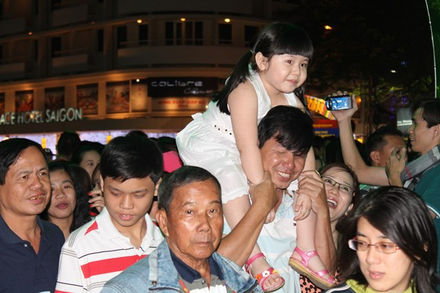 Bố bế con trên vai để di chuyển trong &quot;biển người&quot;