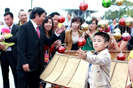 Ông nở nụ cười với một em nhỏ được bố bế trên tay Ông nở nụ cười với một em nhỏ được bố bế trên tay