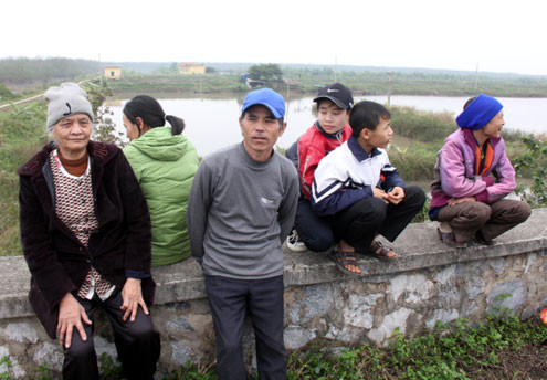 Người dân ngồi trên cống Rộc bàn tán về vụ phá đầm ông Vươn chiều 8/2. Ảnh: Hà Anh. Người dân ngồi trên cống Rộc bàn tán về vụ phá đầm ông Vươn chiều 8/2. Ảnh: Hà Anh.