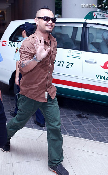 Anh nở nụ cười và vẫy tay chào báo giới.