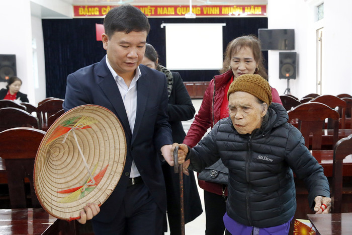 Nhà báo Nguyễn Tiến Bình - Tổng biên tập Báo điện tử Giáo dục Việt Nam trao quà tết cho cụ bà Hà Thị Sơn 89 tuổi, cụ Sơn hiện đang ở một mình, hoàn cảnh rất khó khăn và nuôi 3 đứa cháu nhỏ. Ảnh: Tùng Dương.