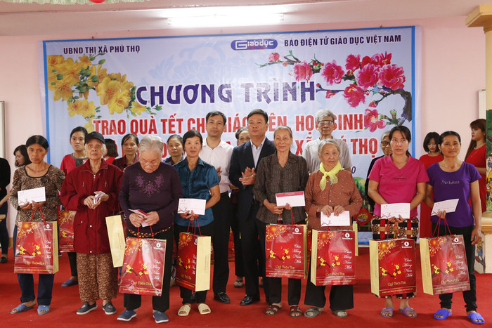 Nhà báo Nguyễn Tiến Bình - Tổng biên tập Báo điện tử Giáo dục Việt Nam (ở giữa bên phải) và ông Nguyễn Tiến Lâm - phó Bí thư thị Ủy, Chủ tịch Ủy ban nhân dân thị xã Phú Thọ (đứng giữa bên trái) với các hộ nghèo trên địa bàn thị xã Phú Thọ. Ảnh: Tùng Dương.